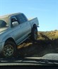 sticks truck half on the ground