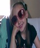 ellissa hideing behind her sun glassers